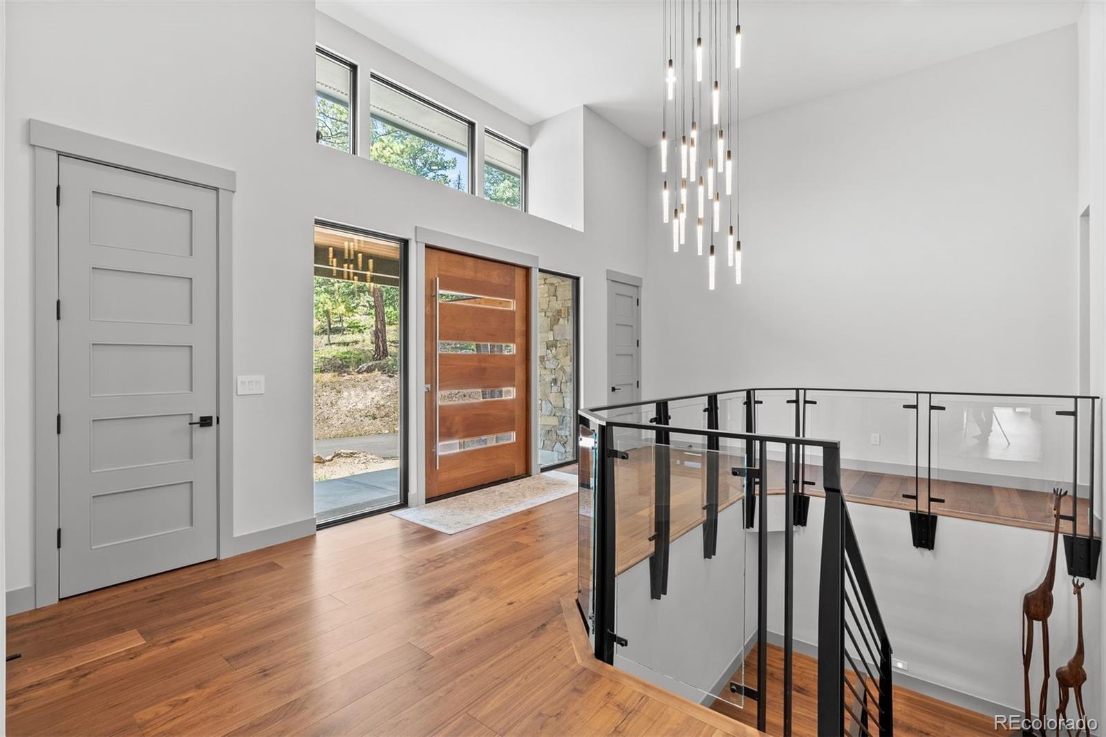 1082 West Meadow Road Evergreen, CO 80439 - Photo 3 of 50 a view of a hallway with couches and wooden floor