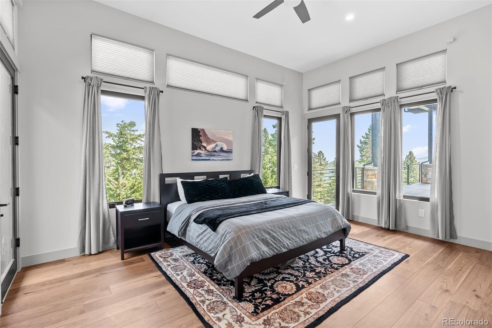 1082 West Meadow Road Evergreen, CO 80439 - Photo 31 of 50 a bedroom with a large bed and a window