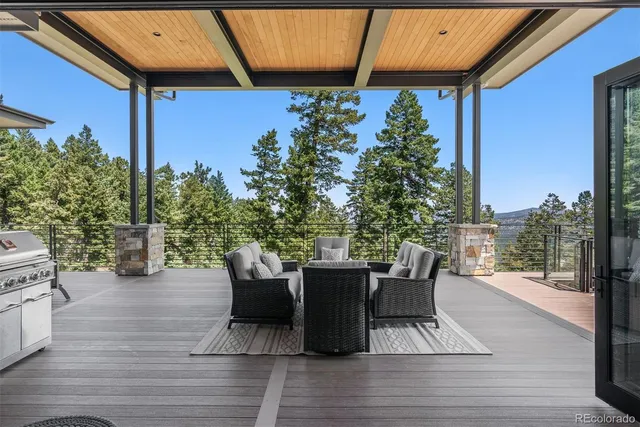 a view of a patio with table and chairs and potted plants