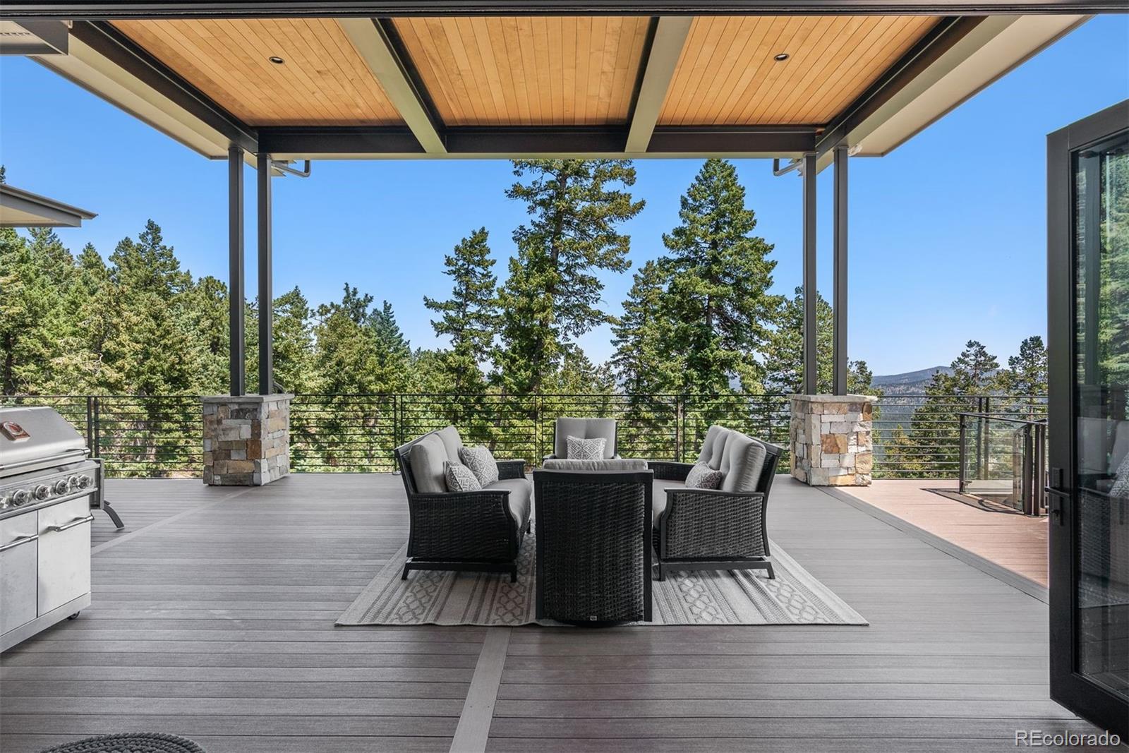 1082 West Meadow Road Evergreen, CO 80439 - Photo 8 of 50 a view of a patio with table and chairs and potted plants