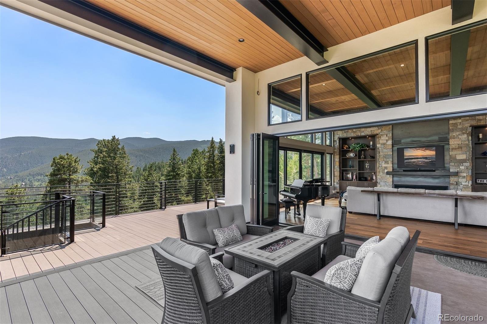 1082 West Meadow Road Evergreen, CO 80439 - Photo 9 of 50 a view of a patio with couches table and chairs