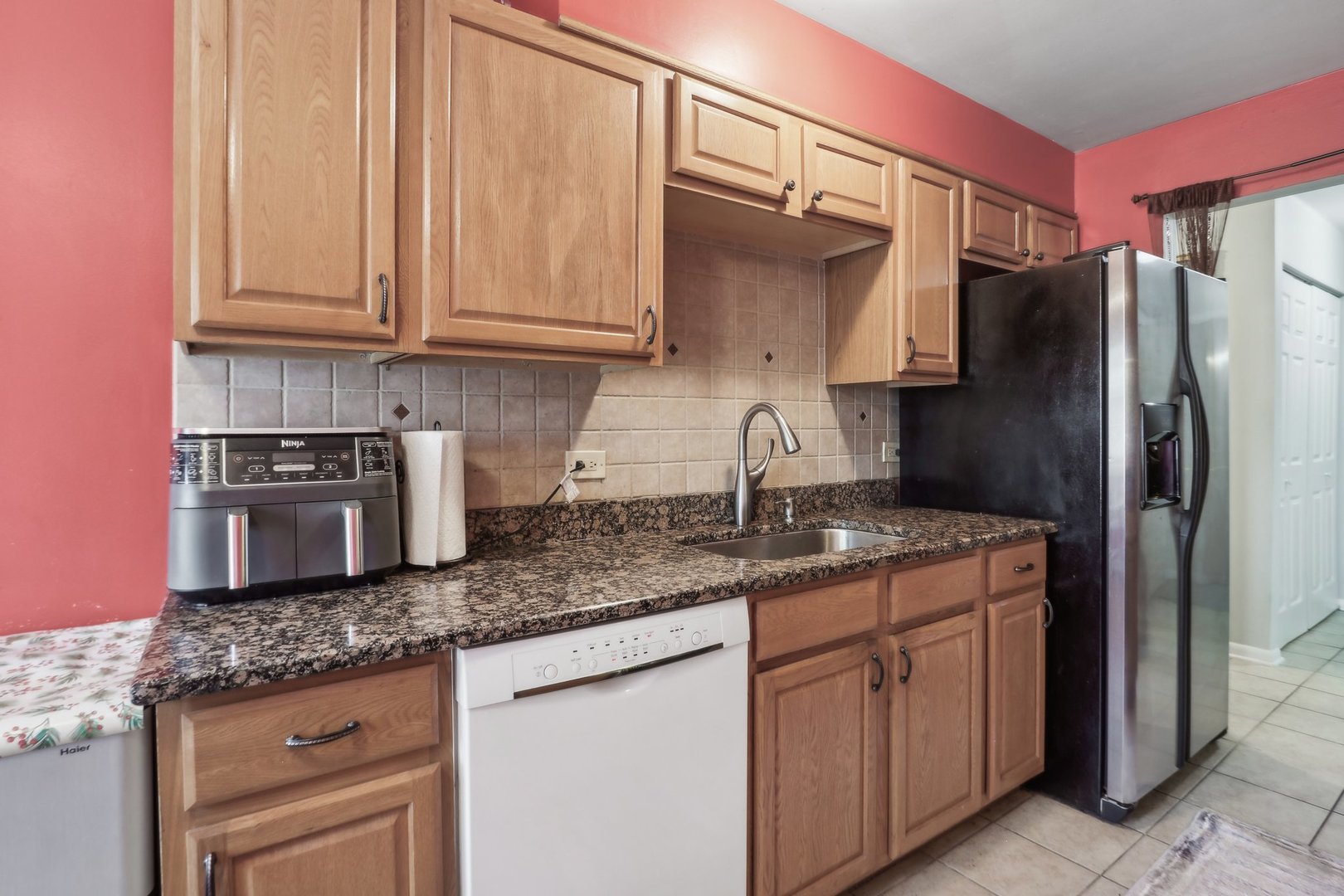 1331 South Finley Road, Unit 215 Lombard, IL 60148 - Photo 8 of 18 a kitchen with stainless steel appliances granite countertop a refrigerator sink and cabinets