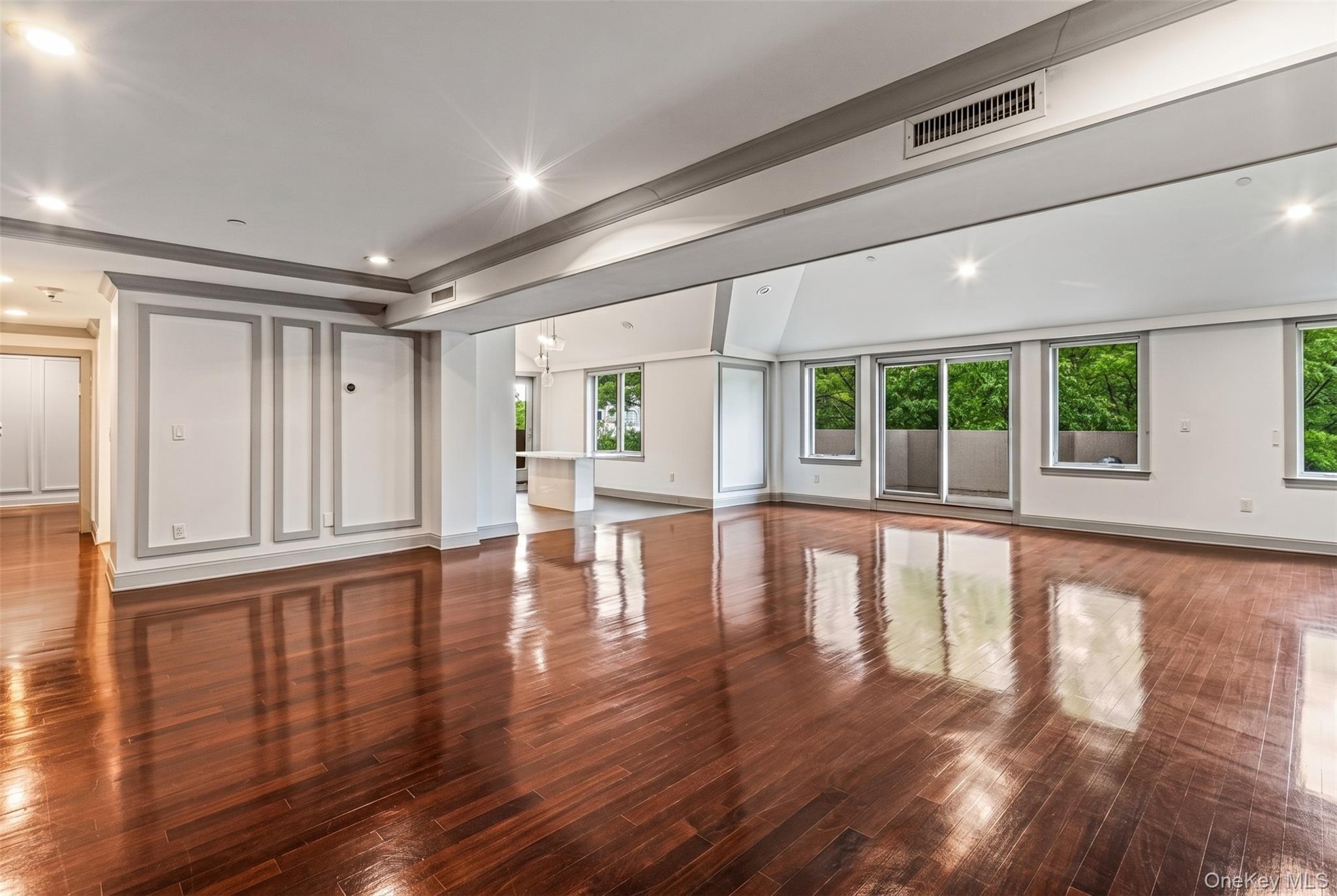 171 Great Neck Road, Unit 4R Great Neck, NY 11021 - Photo 3 of 27 a view of empty room with wooden floor and floor to ceiling window