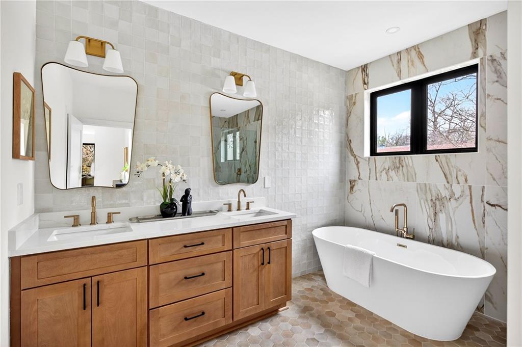 1348 Finley Street Northeast Atlanta, GA 30307 - Photo 18 of 47 a bathroom with a double vanity sink and a bathtub