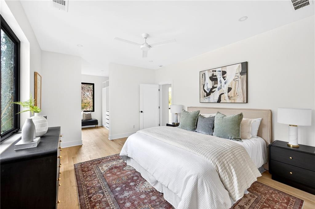 1348 Finley Street Northeast Atlanta, GA 30307 - Photo 27 of 47 a spacious bedroom with a bed and a chandelier