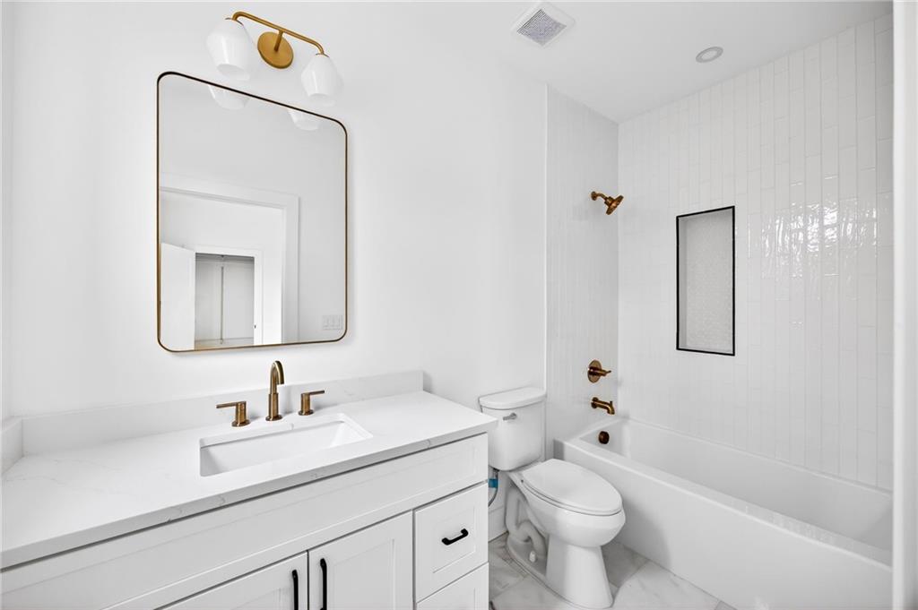1348 Finley Street Northeast Atlanta, GA 30307 - Photo 36 of 47 a bathroom with a toilet sink and mirror