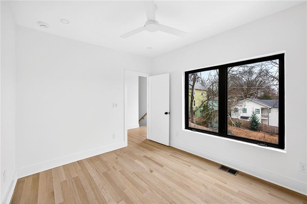 1348 Finley Street Northeast Atlanta, GA 30307 - Photo 40 of 47 a view of an empty room with a window and wooden floor