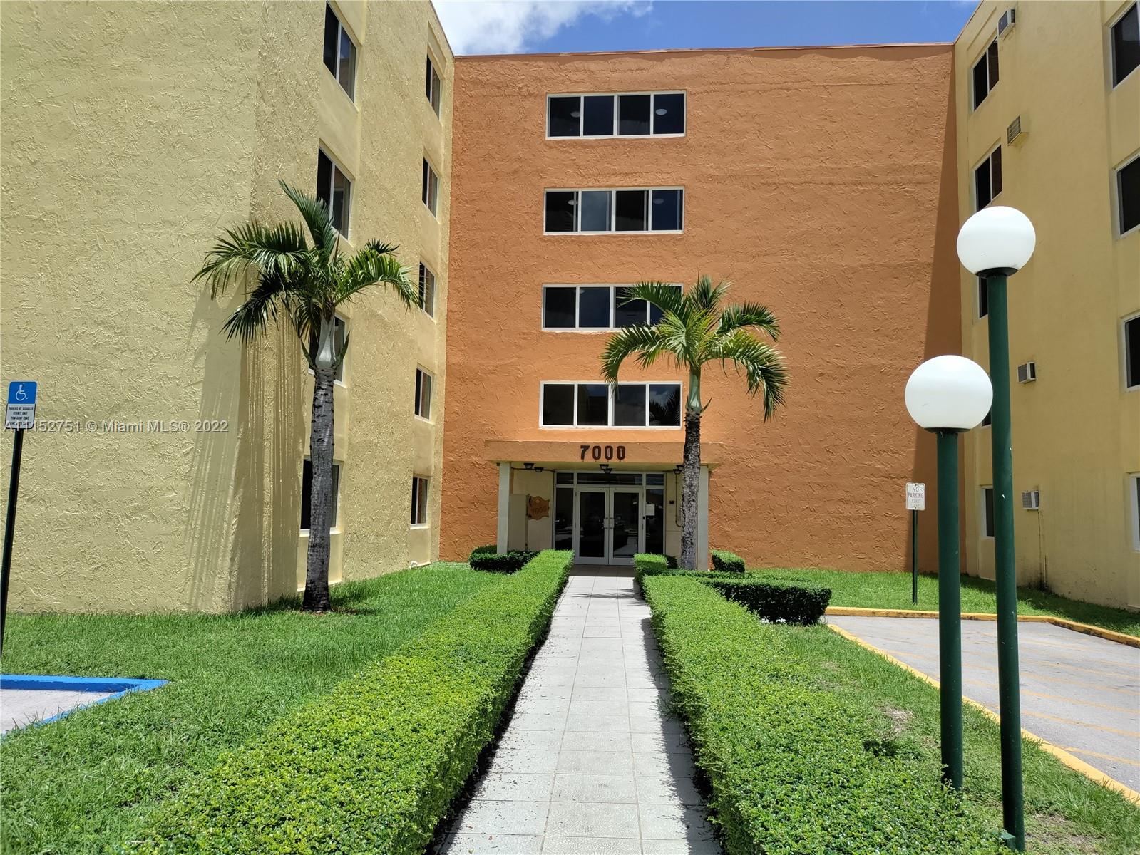 7000 Northwest 186th Street, Unit 4325 Hialeah, FL 33015 - Photo 2 of 10 a front view of a house with a yard and fountain