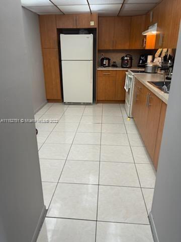 7000 Northwest 186th Street, Unit 4325 Hialeah, FL 33015 - Photo 3 of 10 a kitchen with cabinets a refrigerator and a stove