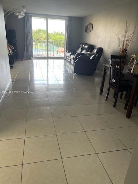 7000 Northwest 186th Street, Unit 4325 Hialeah, FL 33015 - Photo 4 of 10 a living room with furniture a air conditioner vent and a window