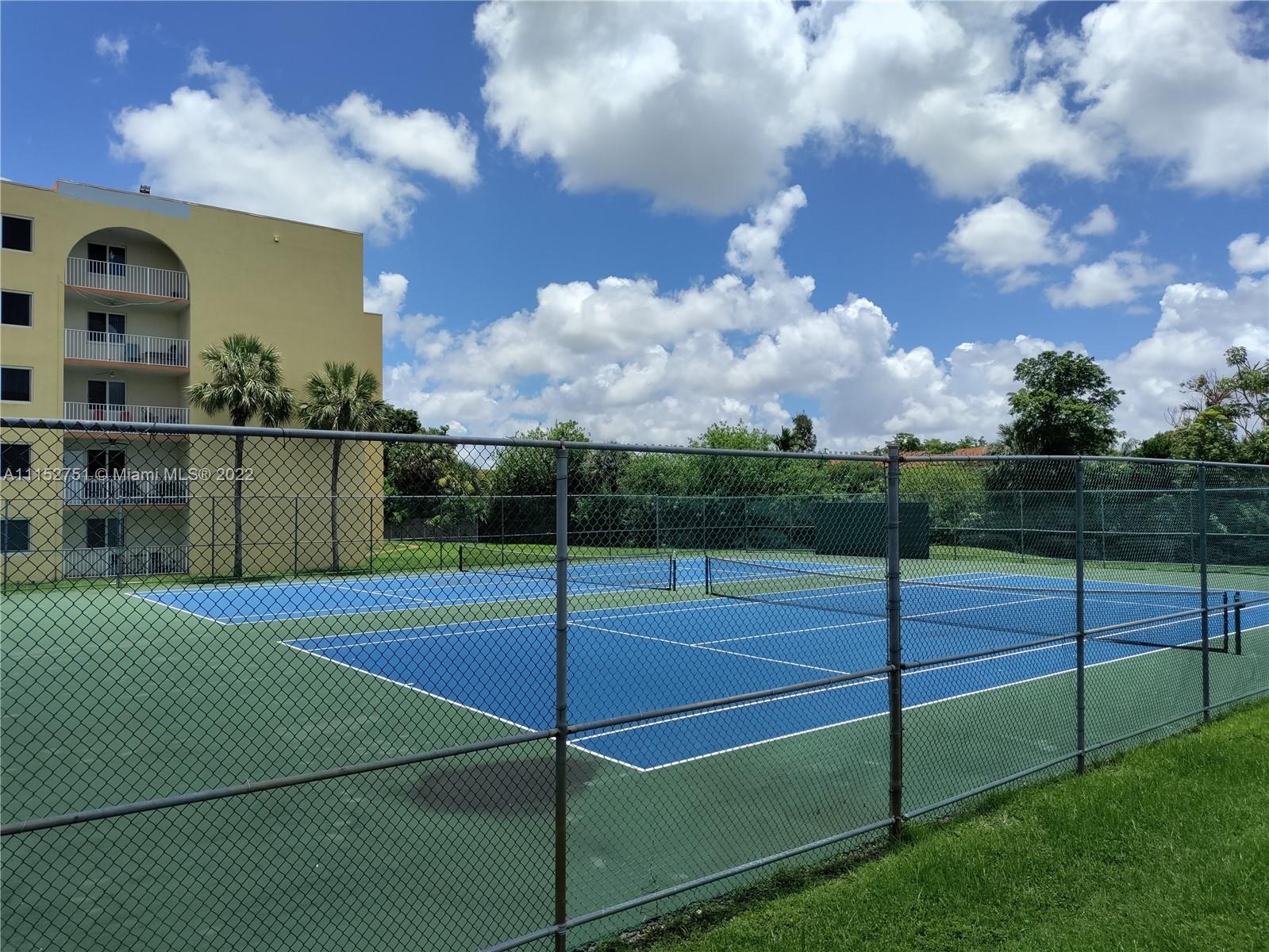 7000 Northwest 186th Street, Unit 4325 Hialeah, FL 33015 - Photo 5 of 10 a view of a tennis court
