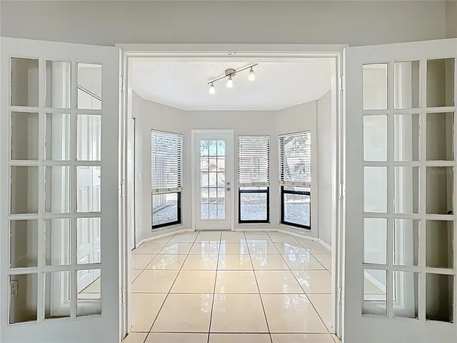 a view of an empty room with window and cabinet