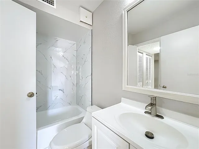 a bathroom with a sink toilet tub and shower