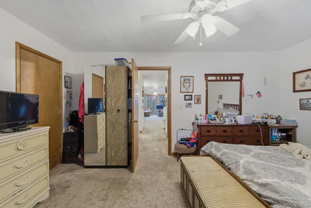 a bathroom with a granite countertop sink a mirror a vanity and a shower