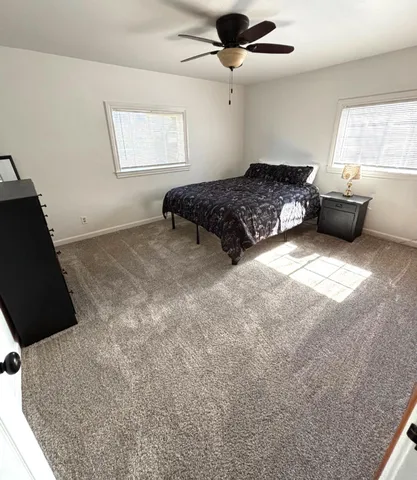 a bedroom with a bed and window