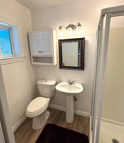 a view of a hallway with wooden floor
