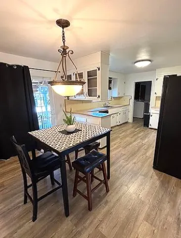 a bedroom with a bed dresser and a large window