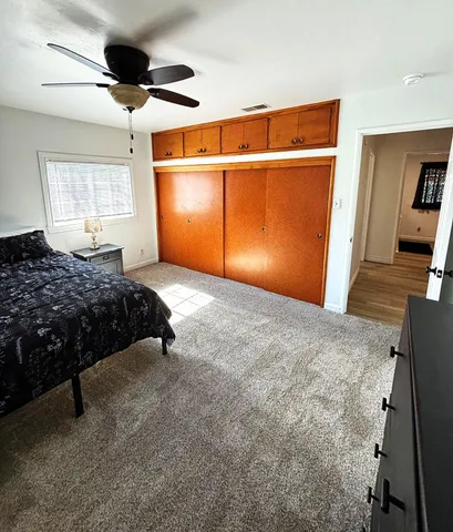 a living room with a bed furniture and a window