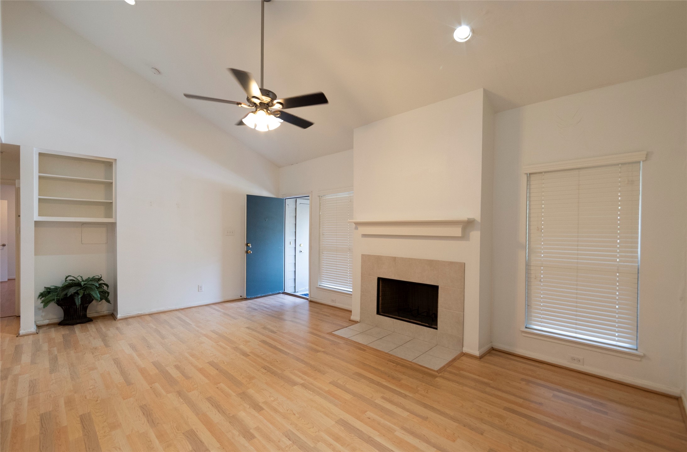 1100 Augusta Drive, Unit 76 Houston, TX 77057 - Photo 3 of 12 a view of empty room with wooden floor and fan