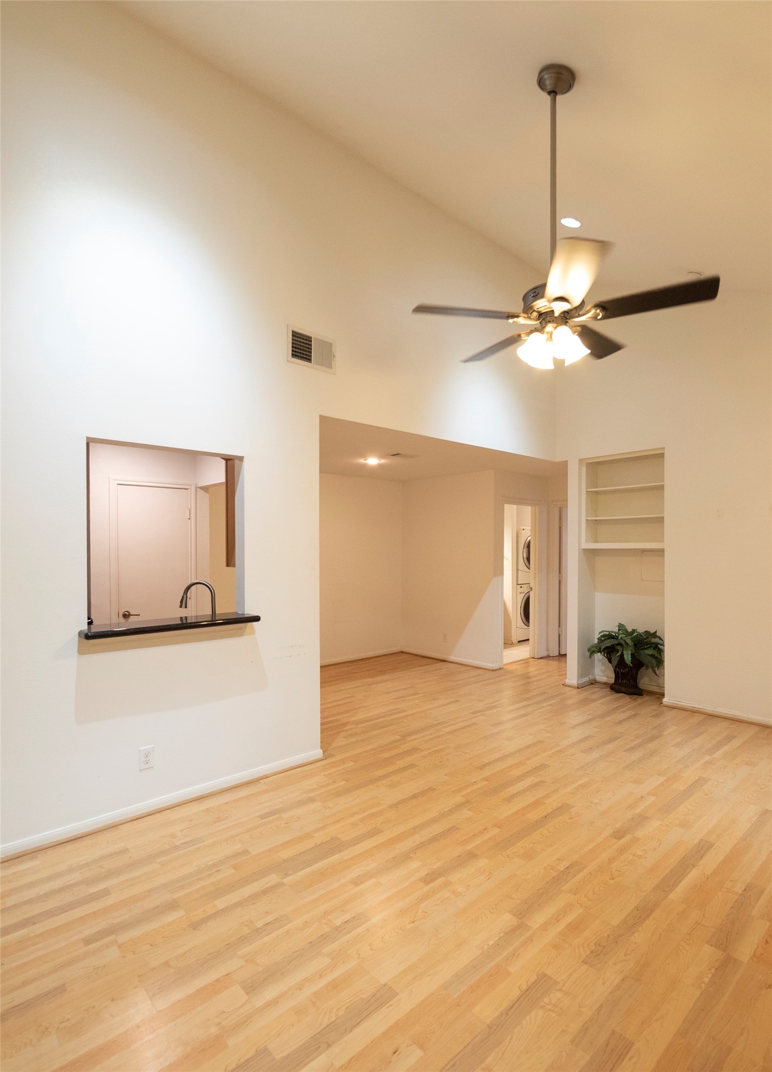 1100 Augusta Drive, Unit 76 Houston, TX 77057 - Photo 5 of 12 a view of a livingroom with a ceiling fan and hardwood floor