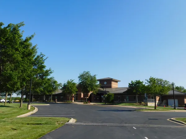 a front view of a building with parking space