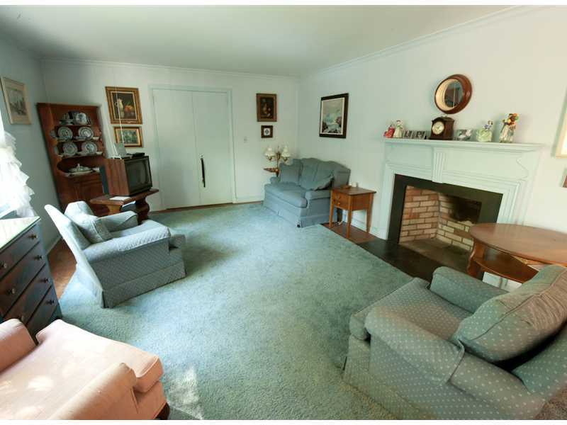 Undisclosed Address Riverside, CT 06878 - Photo 3 of 8 a living room with furniture and a fireplace