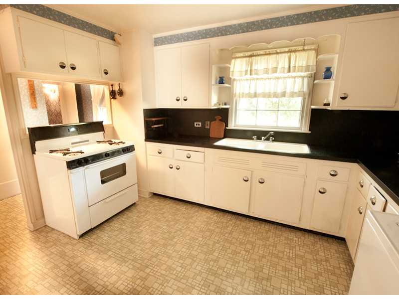 Undisclosed Address Riverside, CT 06878 - Photo 4 of 8 a kitchen with granite countertop white cabinets and white appliances