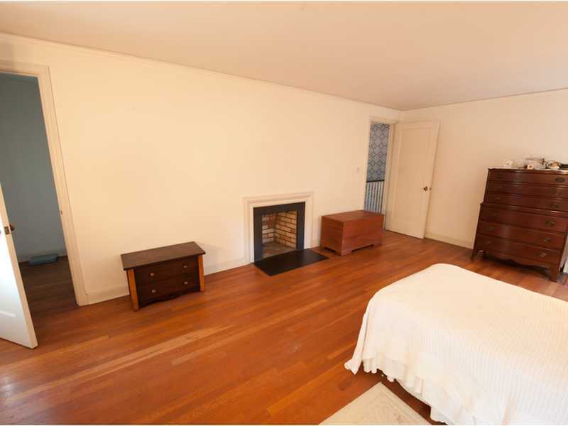 Undisclosed Address Riverside, CT 06878 - Photo 6 of 8 a bedroom with a bed and a television