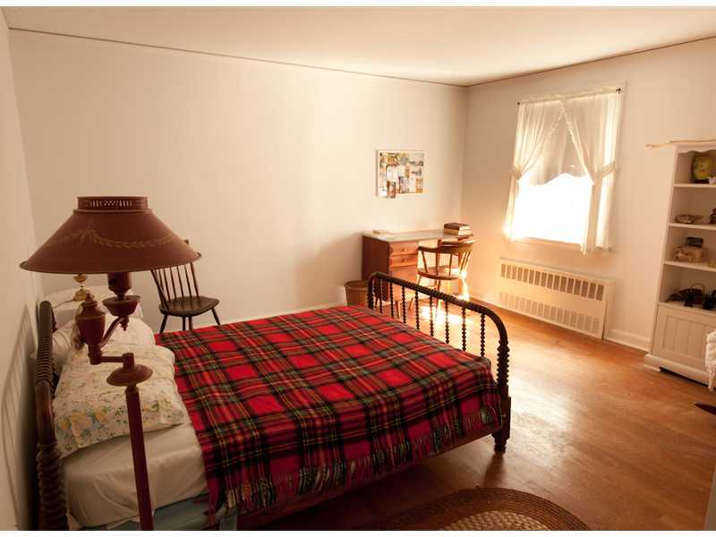 Undisclosed Address Riverside, CT 06878 - Photo 8 of 8 a bedroom with a bed a table and chair