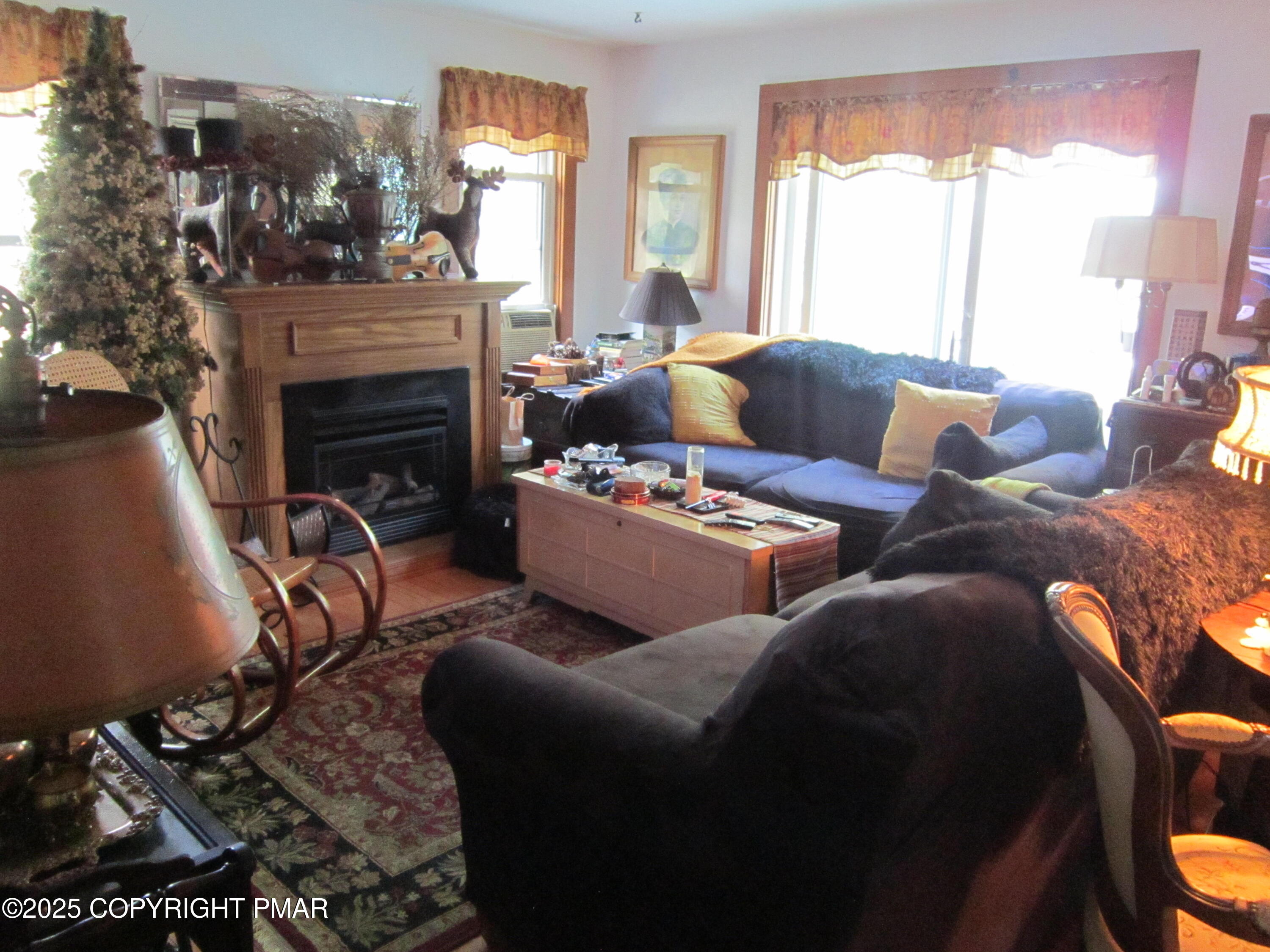 642 Tulip Tree Lane Cresco, PA 18326 - Photo 12 of 40 a living room with furniture a fireplace and a large window