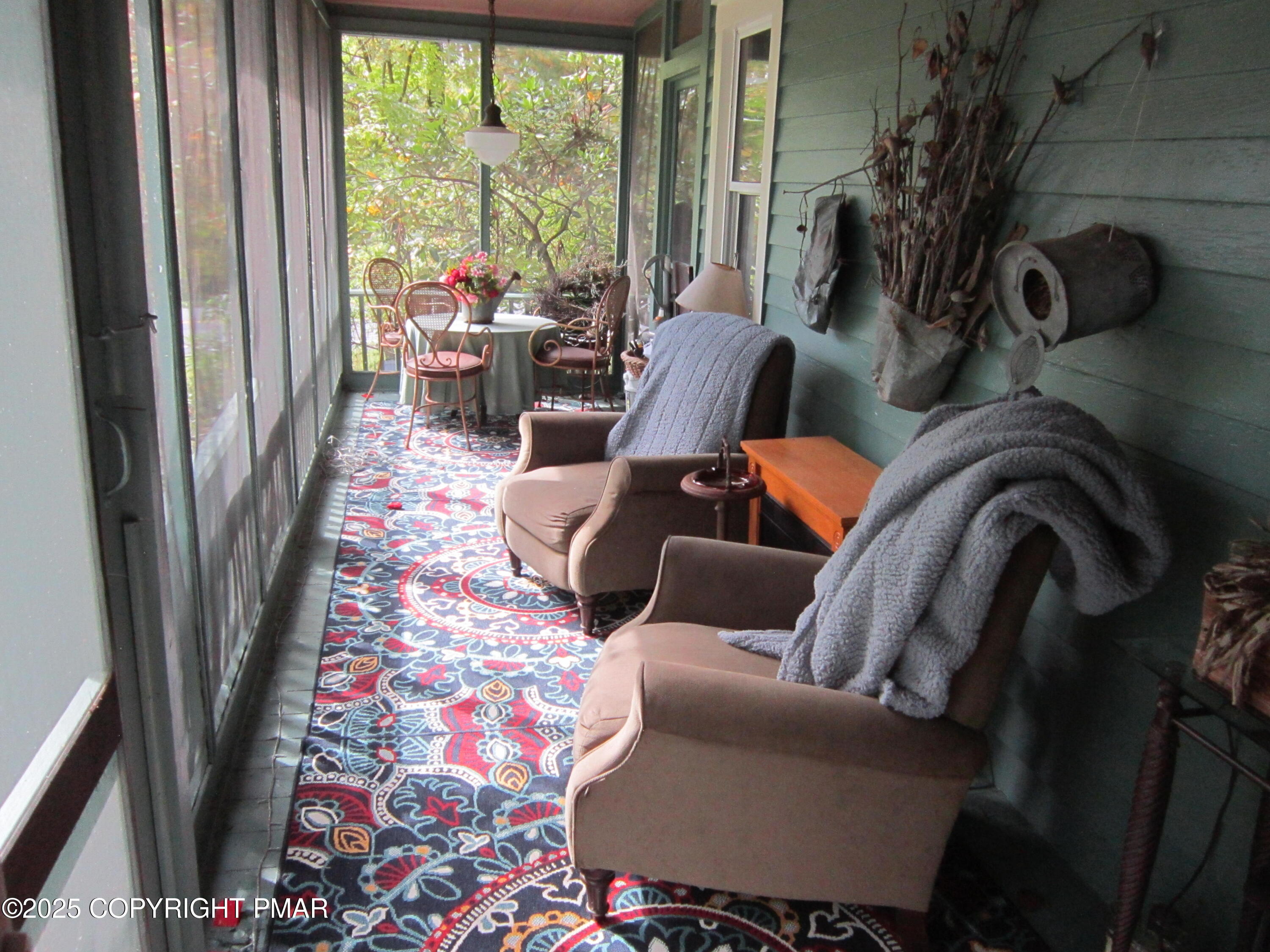 642 Tulip Tree Lane Cresco, PA 18326 - Photo 21 of 40 a living room with furniture and a floor to ceiling window