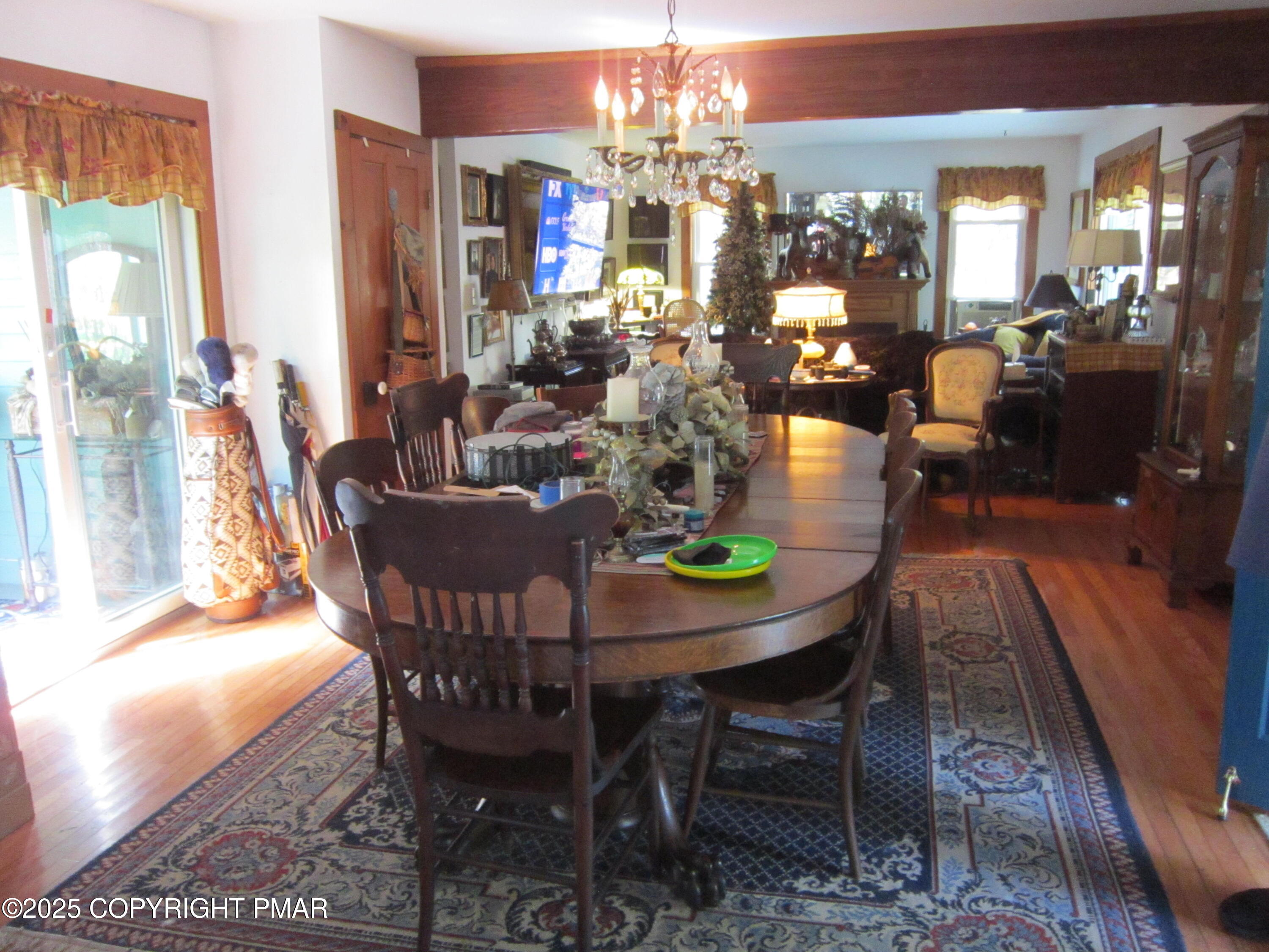 642 Tulip Tree Lane Cresco, PA 18326 - Photo 9 of 40 a view of a dining room with furniture a chandelier and wooden floor