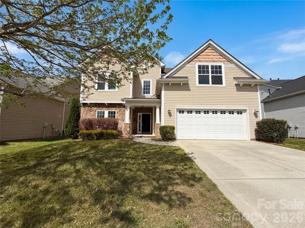 a view of a house with a yard and garage