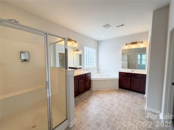 a large bathroom with a large tub and sink