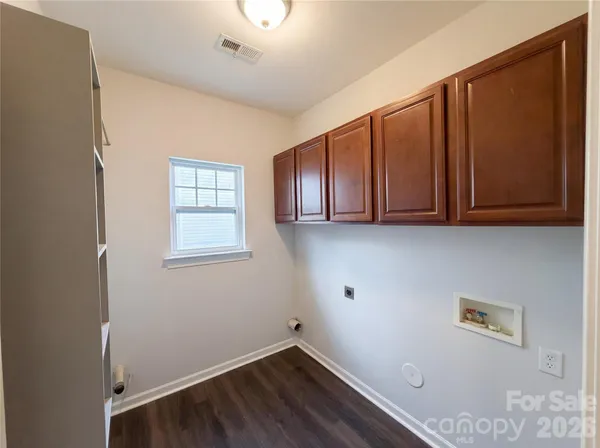 a view of storage and utility room with wooden floor