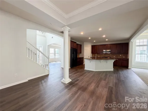 a view of a kitchen with a sink and a refrigerator