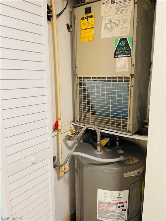 4290 Gulfstream Drive, Unit 9 Naples, FL 34112 - Photo 11 of 16 a bathroom with a sink and a shower curtain