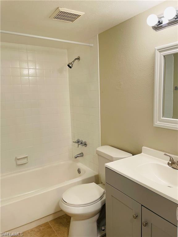 4290 Gulfstream Drive, Unit 9 Naples, FL 34112 - Photo 12 of 16 a bathroom with a sink a toilet and shower