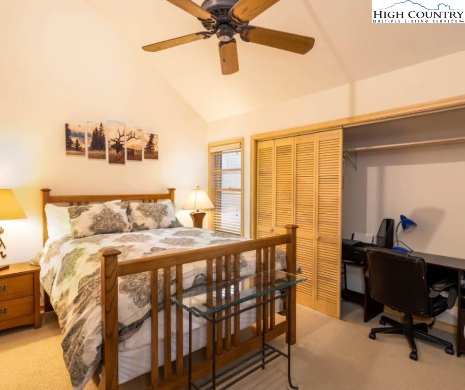 1534 Beech Mountain Parkway Beech Mountain, NC 28604 - Photo 15 of 29 a bedroom with a bed and a table
