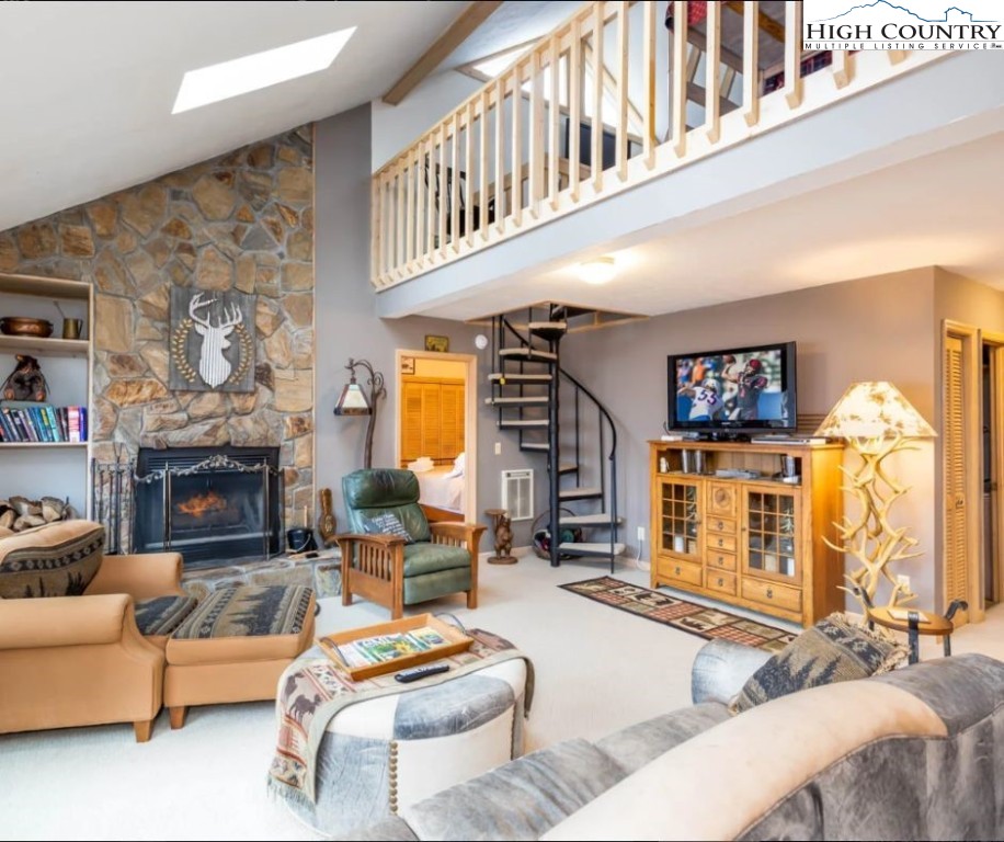 1534 Beech Mountain Parkway Beech Mountain, NC 28604 - Photo 18 of 29 a living room with furniture a fireplace and a large window