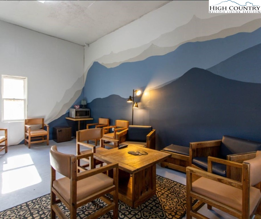 1534 Beech Mountain Parkway Beech Mountain, NC 28604 - Photo 26 of 29 a living room with furniture a rug and a window