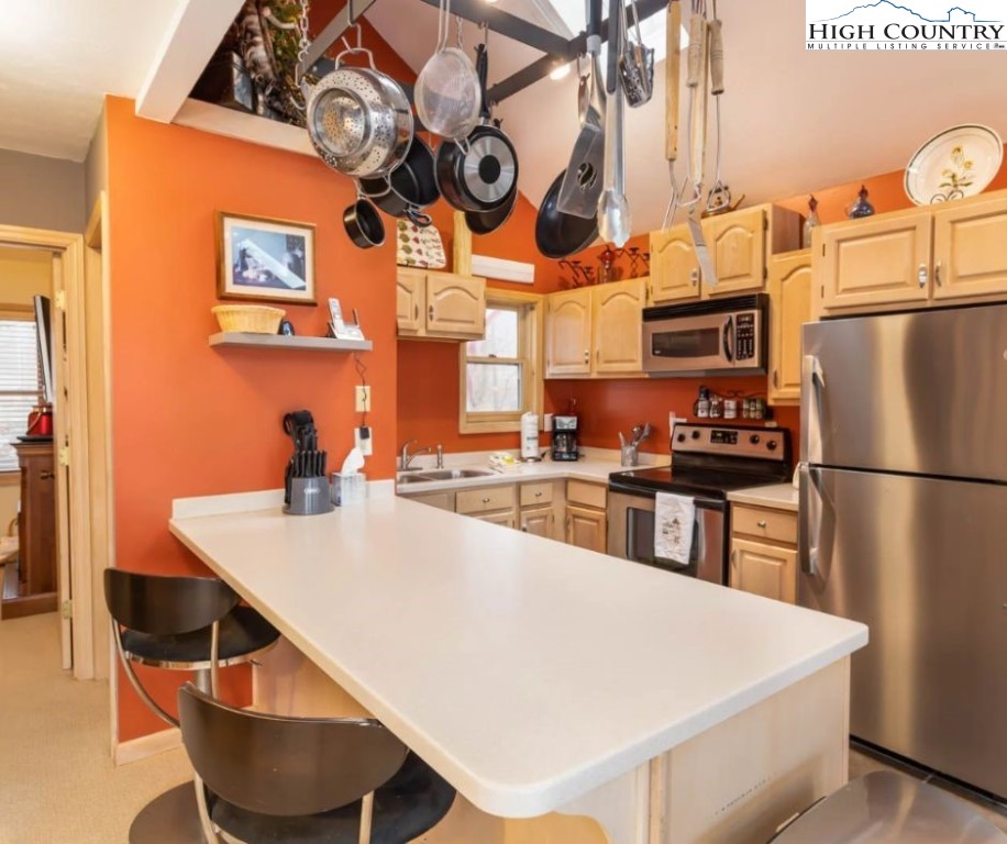 1534 Beech Mountain Parkway Beech Mountain, NC 28604 - Photo 7 of 29 a kitchen with stainless steel appliances granite countertop a sink a stove and a refrigerator