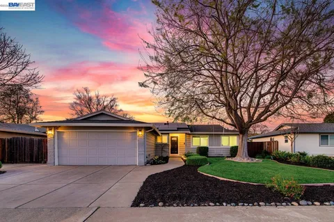 a front view of a house with a yard and a garage