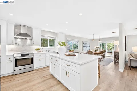 a kitchen with sink stove and cabinets