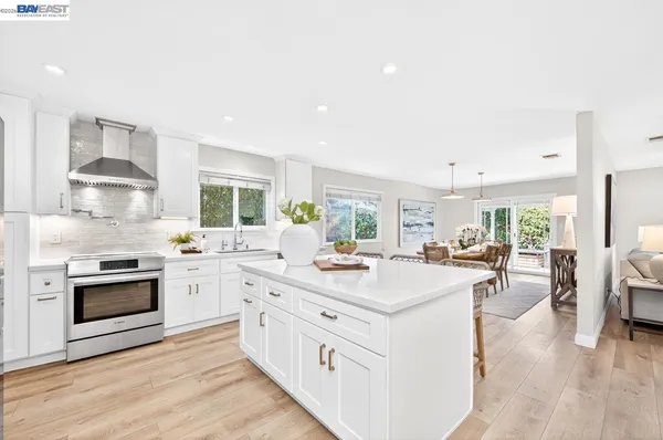a kitchen with sink stove and cabinets