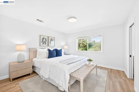 a bedroom with a large bed and a window