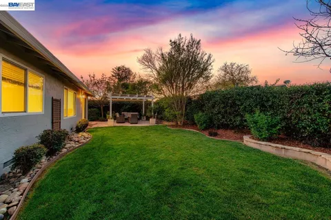 a view of an house with backyard space and garden