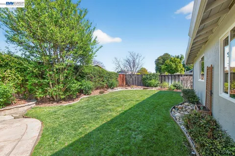 a view of a house with a backyard and a garden