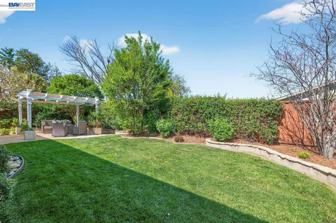 a view of house with backyard and outdoor space