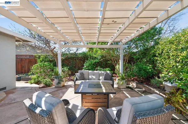 a view of a patio with couches table and chairs and potted plants